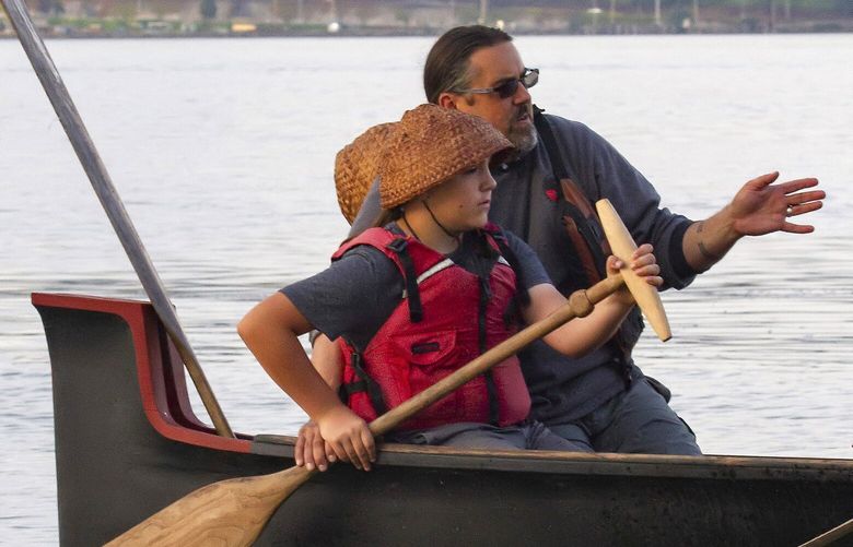 Chinook Indian Nation Chairman Tony Johnson shares knowledge of skippering a canoe with his 14-year-old son during the 2019 Tribal Canoe Journey. The Chinook maintain an unbroken canoe culture, with both the nation and individual families owning and using canoes for ceremony, travel, fishing and work.