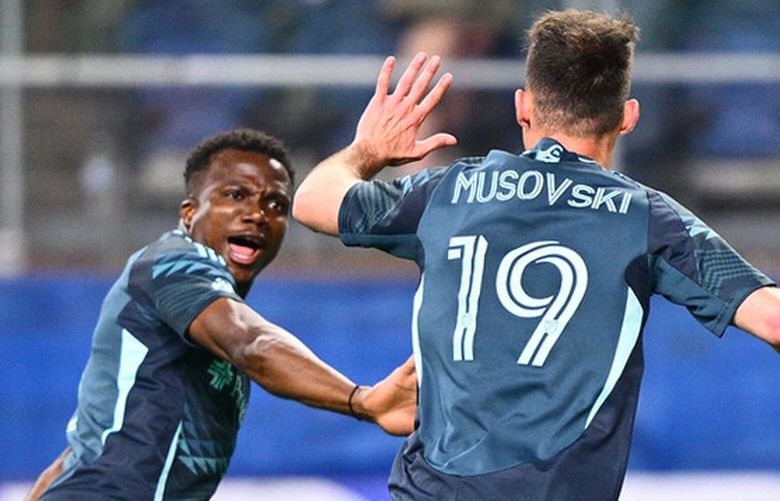 Seattle Sounders’ Nouhou, left, celebrates with Danny Musovski against St. Louis City SC Saturday, May 3, 2025, in Seattle.