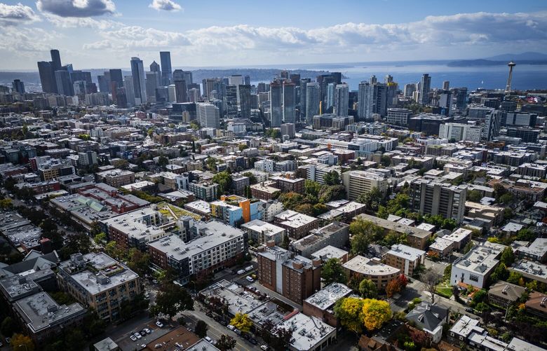 Capitol Hill apartments spread out as far as the eye can see, with downtown Seattle and Puget Sound in the background, seen from the air, Wednesday, Oct. 2, 2024.