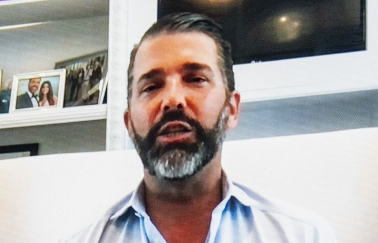 **EMBARGO: No electronic distribution, Web posting or street sales before MONDAY 5:01 A.M. ET, MAY 5, 2025. No exceptions for any reasons. EMBARGO set by source.** FILE – Donald Trump Jr., on video, joined Chase Herro, left, Zach Witkoff, center, and Zachary Folkman at the Blockchain Summit 2025 in Washington on March 26, 2025. Donald Trump Jr. and Eric Trump, who both are helping promote the family cryptocurrency business, have been traveling the world to attend crypto conferences. (Haiyun Jiang/The New York Times) XNYT0744 XNYT0744