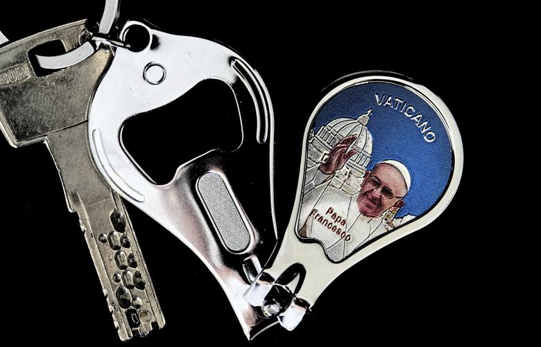 A bottle opener, nail clipper, and key chain with a picture of Pope Francis in Rome, Thursday, May 1, 2025. (AP Photo/Bernat Armangue) BA104 BA104
