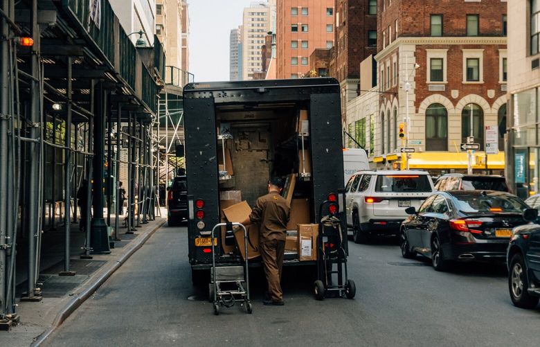 A UPS driver retrieves boxes from the back of his truck, in New York, April 29, 2025. President Donald Trump has ended a shipping loophole that was responsible for lots of e-commerce packages from China to the United States for UPS, FedEx and cargo airlines. (DeSean McClinton-Holland/The New York Times)