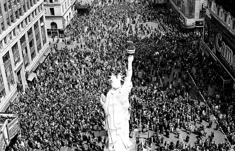 People crowd Times Square at 42nd Street in New York City on May 8, 1945, as the V-E Day celebration continues into the night. (AP Photo/Matty Zimmerman, File) APHS101 APHS101