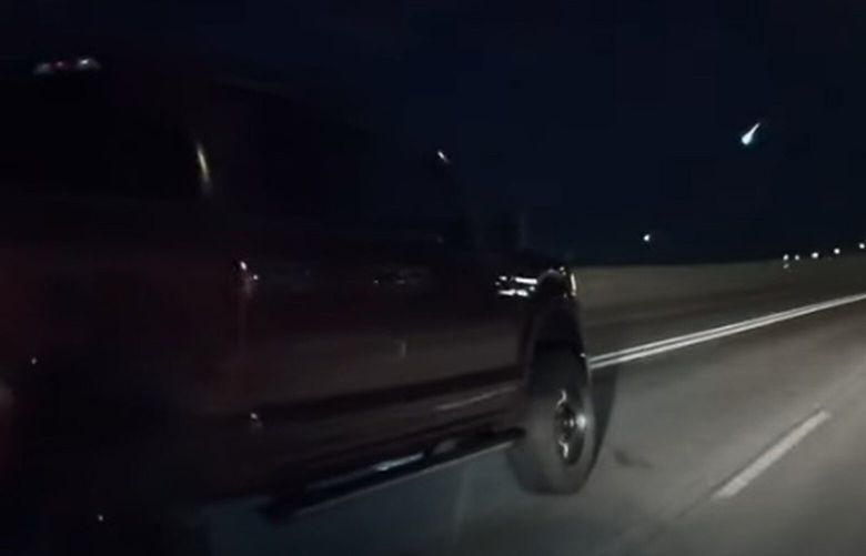 A fireball is seen in the night sky, just to the left of center, in a dashcam video out of Salt Lake City, Utah, on May 3, 2025, while the driver heads northbound on Interstate 15. (Mr. Wyatt/American Meteor Society/TNS) 141817826W 141817826W