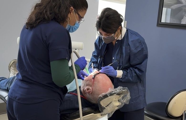 A patient receives a dental procedure at Salt Lake Donated Dental Services, a clinic serving low-income Utah residents, Monday, May 5, 2025, in Salt Lake City, Utah. (AP Photo/Hannah Schoenbaum) RPHS303 RPHS303