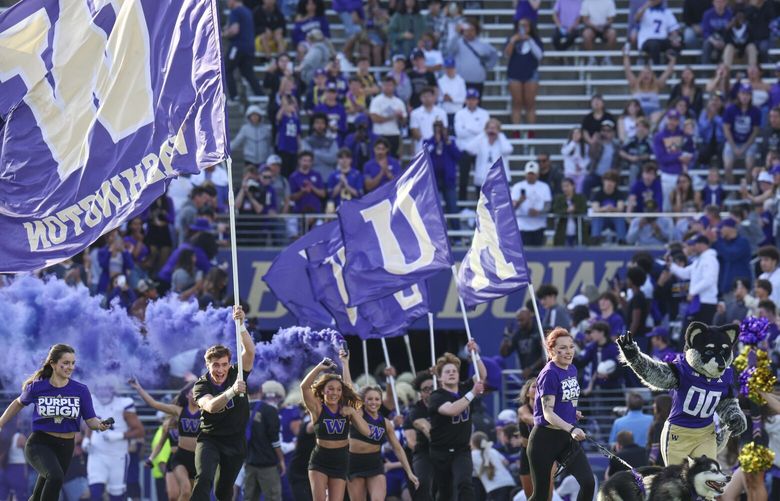 The Washington Huskies run onto the field ahead of a spring scrimmage game at Husky Stadium in Seattle this year, on Friday, May 2, 2025. 229831