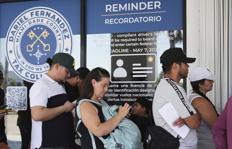 People stand in line outside of a Miami-Dade County Office of the Tax Collector Tuesday, May 6, 2025, in Miami. (AP Photo/Lynne Sladky) FLLS103 FLLS103