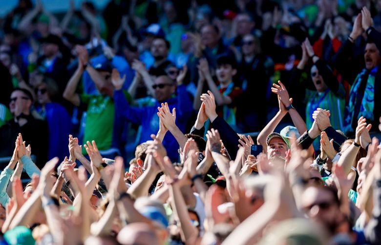 A sun drenched crowd cheers as the Sounders take the field before the start of a game against the Colorado Rapids Saturday, March 16, 2024 in Seattle. 226433