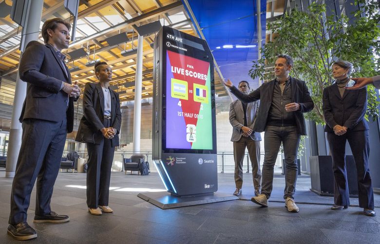 Jon Scholes, CEO, Downtown Seattle Association, (2nd from right) talks about proposed digital advertising kiosks, one of which is on display in City Hall, Thursday, May 8, 2025.  

The Downtown Seattle Association hosts an exhibition of their proposed digital advertising kiosks. They need City Council approval for them.  Thursday is the first committee meeting.

L – R:  Clay Collett, Senior Development Directors for IKE Smart Cities;  Jessica Burton, Development Director, IKE Smart City;   Markham McIntyre, Director of the Office of Economic Development; Scholtes; and Sara Nelson, Seattle City Council President.

If the kiosks are approved, 30 will be installed in the downtown area by June of 2026 in time for the 2026 FIFA World Cup.  Later another 20 will be installed around West Seattle, SODO, Ballard and the University District.

 230044