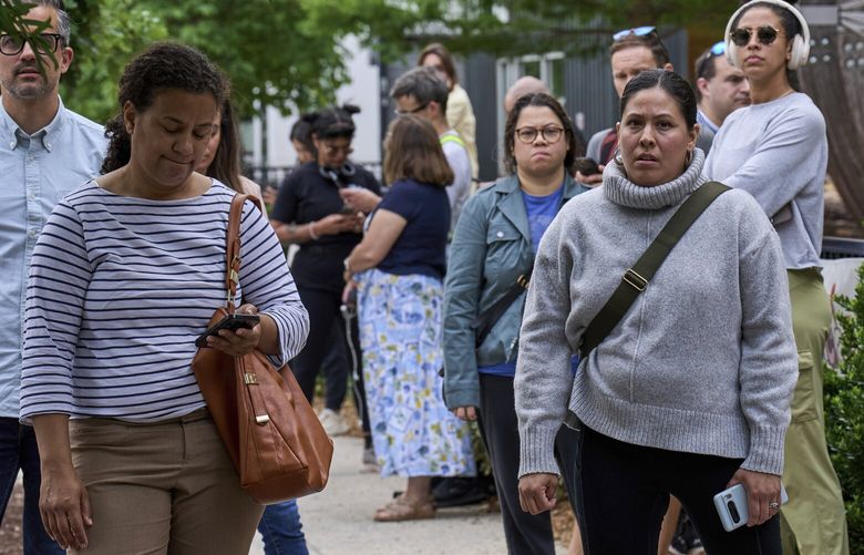 Rio Sigala, right, and other parents of students at Mundo Verde Public Charter School keep a close eye on a Suburban that they thought held an agent of Immigration and Customs Enforcement (ICE) amid fears of impending arrests at schools, Tuesday, May 6, 2025. The vehicle turned out to belong to a television cameraman. “As a Latina, seeing how many parents are out here in solidarity makes you feel less alone,” Sigala said. “You walk around kind of scared and to see everyone come out, it feels hopeful.” (AP Photo/Jacquelyn Martin) DCJM102 DCJM102