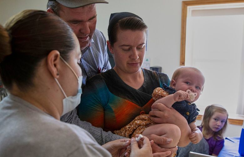 Mennonites Abraham Fehr and Katarina Wall hold their baby as he gets vaccinated weeks after the family fell sick with measles during an outbreak in Cuauhtemoc, Chihuahua state, Mexico, Thursday, May 1, 2025. (AP Photo/Megan Janetsky) RPTMJ101 RPTMJ101