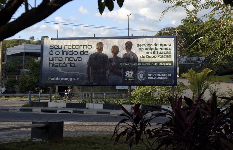 A sign advertises services for deportees from the US.  Photographer: Ana Caroline de Lima/Bloomberg