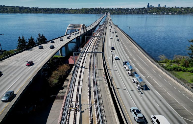 Work is done on the Line 2 light rail tracks (at center) on the I-90 floating bridge.  It is the only train tracks built on a floating bridge in the world.  Shot Monday, April 21, 2025.  Looking towards Seattle from Mercer Island.

This is the part of the Line 2 East Link Extension part of Sound Transit’s Light Rail section that runs from Seattle’s International District to Judkins Park station in Seattle, across the floating I-90 bridge to the Redmond Technology station in Redmond.  The East Link Extension currently includes ten stations — the International District station, the Judkins Park station, the Mercer Island station, the South Bellevue station, East Main station, Bellevue Downtown station, Wilburton station, Spring District station, BelRed station, Overlake Village station and then the Redmond Technology station.  Two more stations in Redmond,  the SE Redmond Station and Downtown Station, will open in May of 2025. 229816