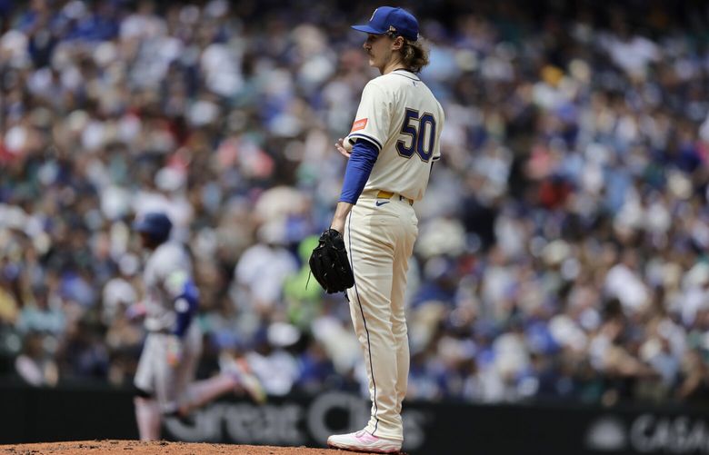 Seattle Mariners starting pitcher Bryce Miller (50) stands on the mound as Toronto Blue Jays’ George Springer, back left, rounds the bases after hitting a three-run home run during the fifth inning of a baseball game Sunday, May 11, 2025, in Seattle. (AP Photo/John Froschauer) WAJF110 WAJF110