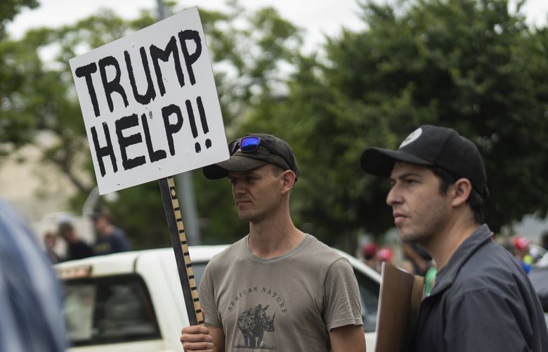 FILE – White South Africans demonstrate in support of U.S. President Donald Trump in front of the U.S. embassy in Pretoria, South Africa, Saturday, Feb. 15, 2025. (AP Photo/Jerome Delay, File) NY115 NY115