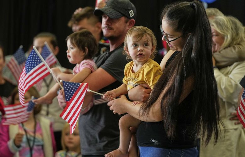 Afrikaner refugees from South Africa holding American flags arrive, Monday, May 12, 2025, at Dulles International Airport in Dulles, Va. (AP Photo/Julia Demaree Nikhinson) VAPU519 VAPU519