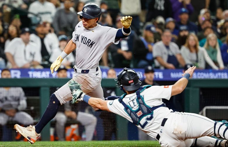 Cal raleigh can’t make the tag on New York’s Oswaldo Cabrera in the ninth.  Cabrera however suffered a serious injury attempting to score, and was taken off the field by ambulance.  The New York Yankees played the Seattle Mariners in Major League Baseball Monday, May 12, 2025 at T-Mobile Park, in Seattle, WA. 230028