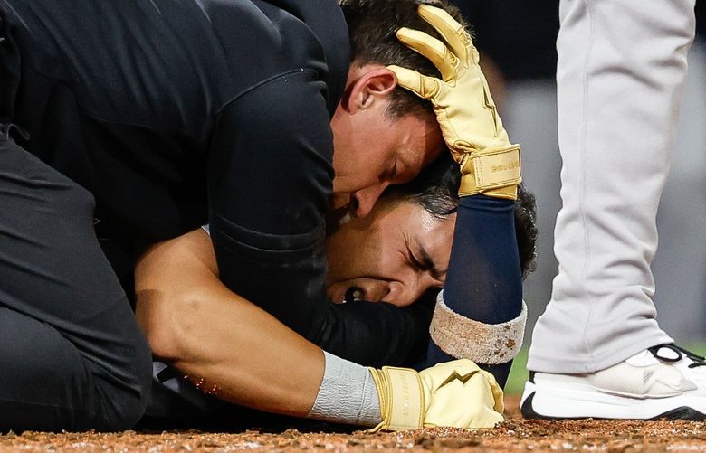 Trainers call for help after New York third baseman Oswaldo Cabrera suffers a seriious injury attempting to score from third in the inning as his ankle turns as he tries to reach home.  The New York Yankees played the Seattle Mariners in Major League Baseball Monday, May 12, 2025 at T-Mobile Park, in Seattle, WA. 230028