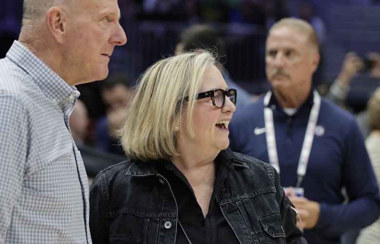 Steve Balmer, owner of the Los Angeles Clippers, with stands with Jody Allen, chair of the Portland Trail Blazers, right, on the court before a preseason NBA basketball game between the two teams, Friday, Oct. 11, 2024, in Seattle. (AP Photo/John Froschauer)