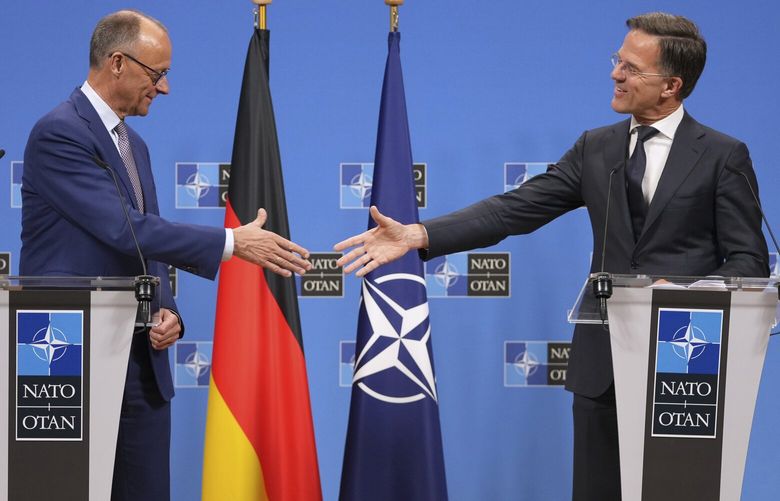 Germany’s Chancellor Friedrich Merz, left, shakes hands with NATO Secretary General Mark Rutte during a media conferenc6 at NATO headquarters in Brussels, Friday, May 9, 2025. (AP Photo/Virginia Mayo) VLM136 VLM136