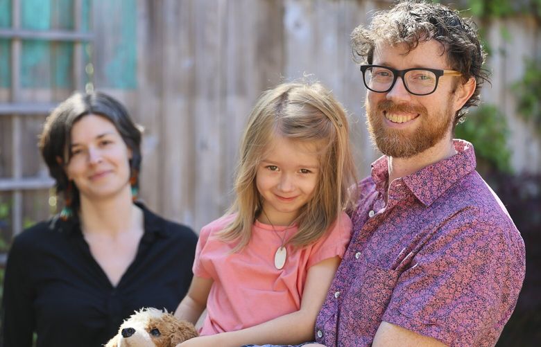 Patrick Conway, who is deaf, with his wife Susannah Balestracci is trying to get one of his children, Luvi Balestracci, 5 and not deaf, into TOPS K-8, a school that has a program for children who are deaf and hard of hearing to be allow him to fully participate in his child’s education. Photographed at their home in Seattle, Washington on May 9, 2025. 230063