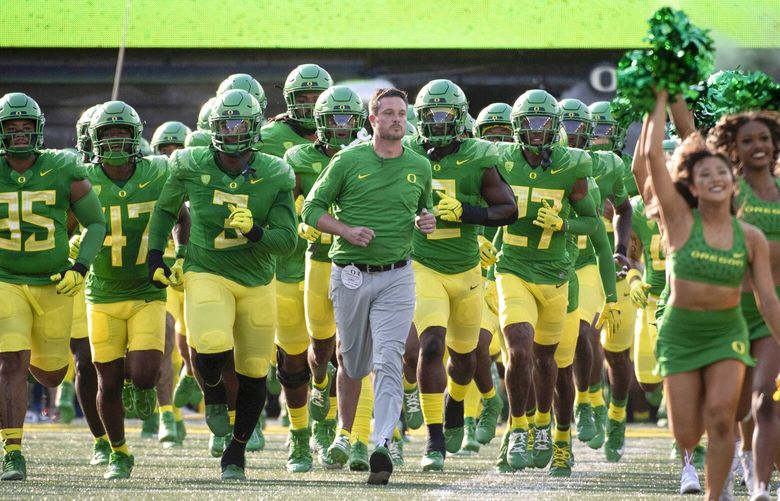 Oregon head coach Dan Lanning leads his team onto the field to play Hawaii in an NCAA college football game, Sept. 16, 2023, in Eugene, Ore.