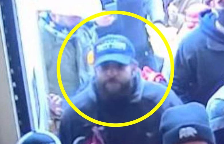 In this image from U.S. Capitol Police security video, released and annotated by the Justice Department in the Statement of Facts supporting an arrest warrant, Taylor Taranto, circled in yellow, enters the U.S. Capitol through the Upper West Terrace door on Jan. 6, 2021, in Washington. A Capitol riot suspect who had guns and hundreds of rounds of ammunition in his van when he was arrested near former President Barack Obama’s Washington home has been indicted on federal firearms charges. Taranto was already facing misdemeanor charges stemming from his alleged involvement in the Jan. 6 riot. (Justice Department via AP)