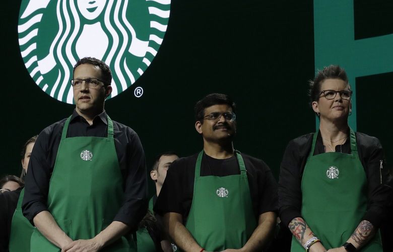 FILE – Starbucks baristas stand on stage, March 20, 2019, during an annual shareholders meeting in Seattle. (AP Photo/Ted S. Warren, file) NYPS217 NYPS217