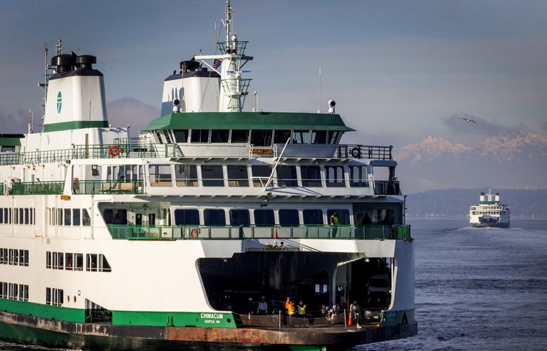 The Washington State Ferry Chimacum, left, arrives at Colman Dock from Bremerton as the Suquamish heads back out to sea en route to Bainbridge Island, Thursday morning, Jan. 23, 2025, in downtown Seattle. The ferry systems of Puget Sound have all shown an increase in riders, especially Kitsap Transit Fast Ferries.