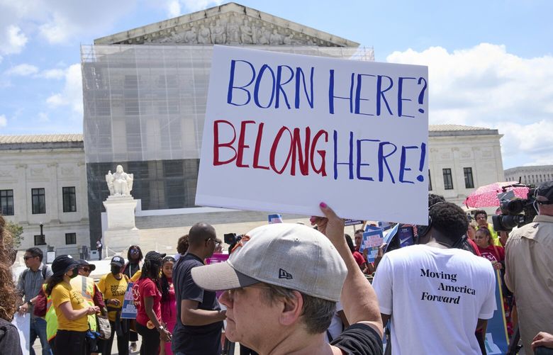 Jenny Harris, of Baltimore, protests in support of birthright citizenship and the immigrant community, Thursday, May 15, 2025, outside of the Supreme Court in Washington. (AP Photo/Jacquelyn Martin) DCJM107 DCJM107