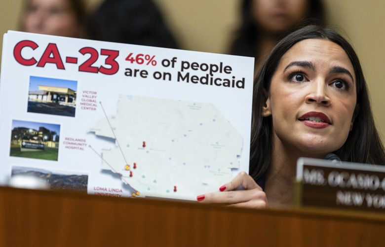 Rep. Alexandria Ocasio-Cortez (D-N.Y.) holds up a sign showing the number of people on Medicaid in the congressional district of Rep. Jay Obernotle (R-Calif.) during a House Energy and Commerce Committee full committee markup session for the Republican’s sweeping domestic policy bill on Capitol Hill in Washington, May 13, 2025. (Eric Lee/The New York Times) XNYT0223 XNYT0223