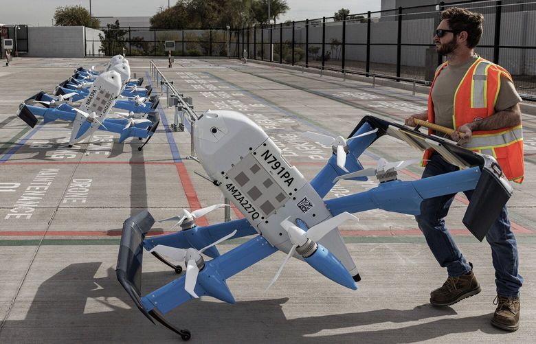 Amazon employees handle delivery drones at at the Amazon Same Day Delivery site in Tolleson, Arizona, Dec. 16,2024. A recent visit to the company’s overhauled drone delivery program in Arizona left some impressed by the drones, but skeptical that the public will welcome them. (Adriana Zehbrauskas/The New York Times) XNYT0889 XNYT0889