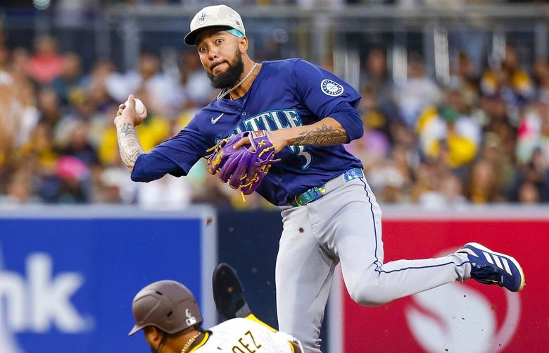 Seattle Mariners shortstop J.P. Crawford, top, turns a double play over San Diego Padres’ Luis Arraez (4) during the third inning of a baseball game Friday, May 16, 2025, in San Diego. CABS110