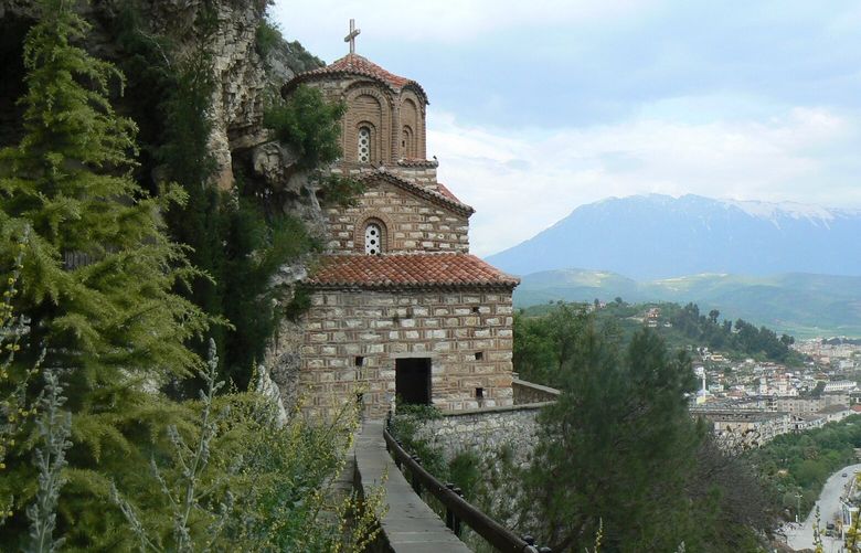 The 13th-century chapel of St. Michael’s is wedged into the hillside overlooking a river in Berati, Albania. Carol Pucci/The Seattle Times.