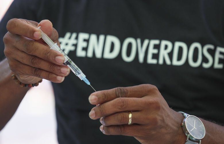Michael Walker, who works with Evergreen Treatment Services as the vice president of employee services, practices administering Narcan during a remembrance and awareness event ahead of International Overdose Awareness Day, at Westlake Park in Seattle on Thursday, August 29, 2024.  227890