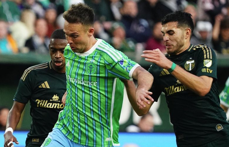 Sounders forward Danny Musovski drives against Timbers midfielder Cristhian Paredes as Seattle plays Portland Saturday May 17, 2025 at Providence Park in Portland.