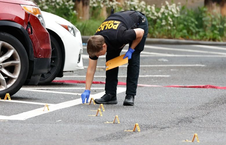 Seattle Police collect evidence on S. Washington St. as they investigate the scene where three people were killed and one other critically wounded in a shooting in the Pioneer Square neighborhood of Seattle on Saturday, May 17, 2025. S. Washington St was blocked off between 2nd Ave S. and Occidental Ave. S.