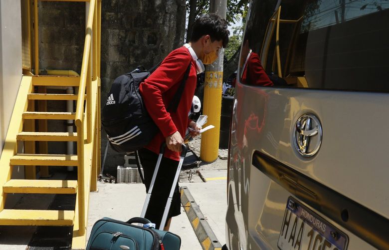 A Honduran migrant who returned voluntarily from the United States walks after arriving at Ramon Villeda Morales Airport in San Pedro Sula, Honduras, Monday, May 19, 2025. (AP Photo/Delmer Martinez) MXEV102 MXEV102