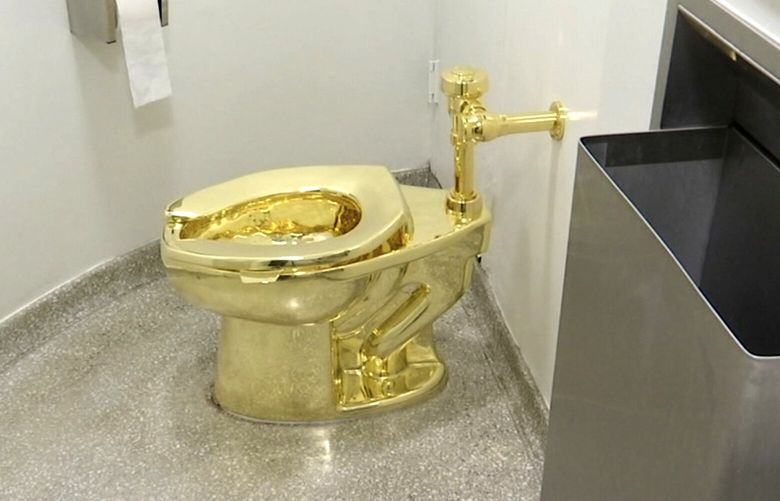 FILE – This Sept. 16, 2016 file image made from a video shows the 18-karat toilet, titled “America,” by Maurizio Cattelan in the restroom of the Solomon R. Guggenheim Museum in New York. (AP Photo, File) DSOB110 DSOB110