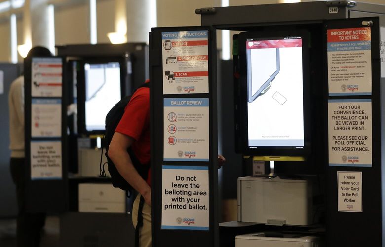 FILE – People vote at voting booths in the Georgia’s primary election at Park Tavern June 9, 2020, in Atlanta. (AP Photo/Brynn Anderson, File) WX152 WX152