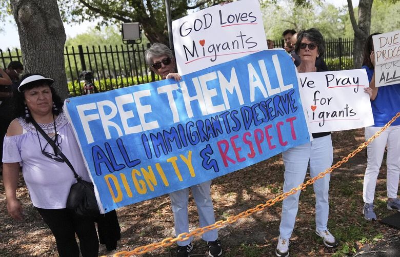 Advocates for migrant rights hold signs outside the South Florida office of U.S. Immigration and Customs Enforcement and Enforcement and Removal Operations, following a press conference with Gov. Ron DeSantis on immigration enforcement, Thursday, May 1, 2025, in Miramar, Fla. (AP Photo/Rebecca Blackwell) FLRB114 FLRB114