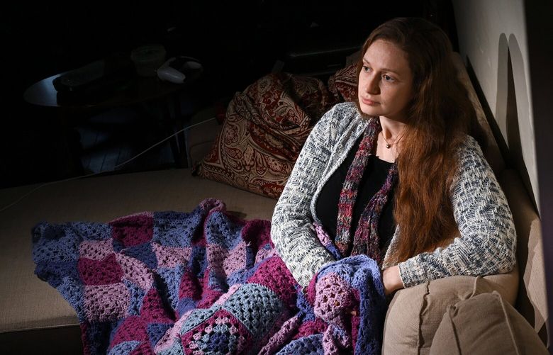 Emily Cross sits in her Baltimore home with a blanket made by her mother, Caitlin Cross-Barnet. MUST CREDIT: Matt McClain/The Washington Post