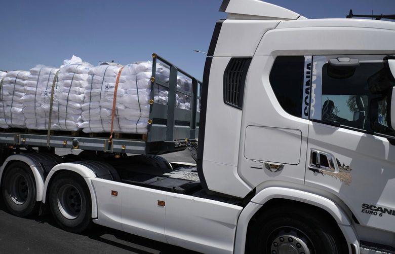 A truck loaded with humanitarian aid for the Gaza Strip makes its way to the Kerem Shalom crossing in southern Israel, Israel-Gaza border, Tuesday, May 20, 2025. (AP Photo/Maya Alleruzzo) XMA101 XMA101