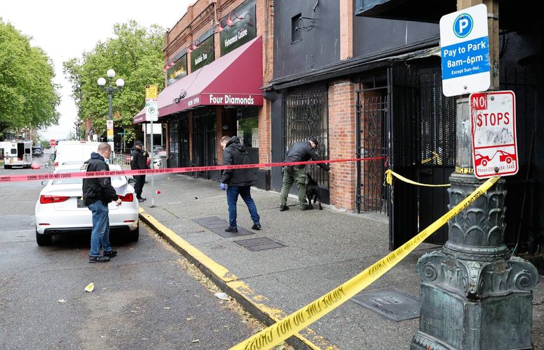Seattle Police investigate the scene where three people were killed and one other critically wounded in a shooting in the Pioneer Square neighborhood of Seattle on Saturday, May 17, 2025. S. Washington St was blocked off between 2nd Ave S. and Occidental Ave. S.