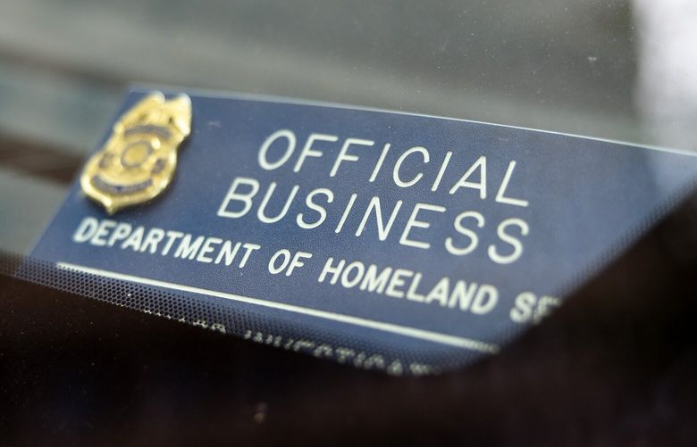 A Department of Homeland Security tag is seen on the dash of a vehicle outside of Seattle Immigration Court on Tuesday, May 20, 2025.
