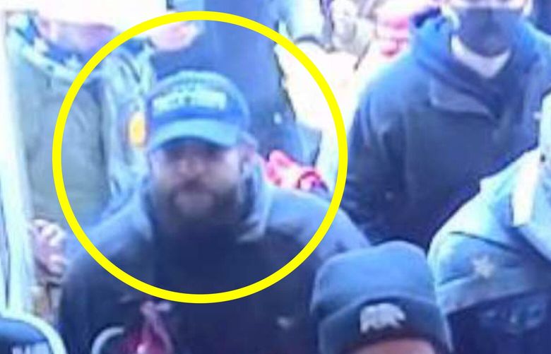 In this image from U.S. Capitol Police security video, released and annotated by the Justice Department in the Statement of Facts supporting an arrest warrant, Taylor Taranto, circled in yellow, enters the U.S. Capitol through the Upper West Terrace door on Jan. 6, 2021, in Washington. A Capitol riot suspect who had guns and hundreds of rounds of ammunition in his van when he was arrested near former President Barack Obama’s Washington home has been indicted on federal firearms charges. Taranto was already facing misdemeanor charges stemming from his alleged involvement in the Jan. 6 riot. (Justice Department via AP)