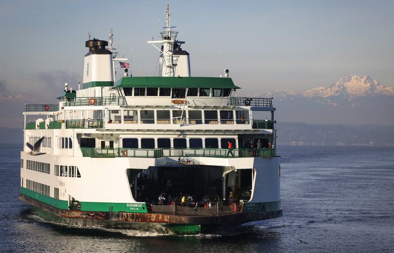 With the Olympic Mountain peaks The Brothers in the background, the Washington State Ferry Suquamish sails from Bainbridge Island, arriving at Colman Dock, Thursday morning, Jan. 23, 2025, in downtown Seattle.