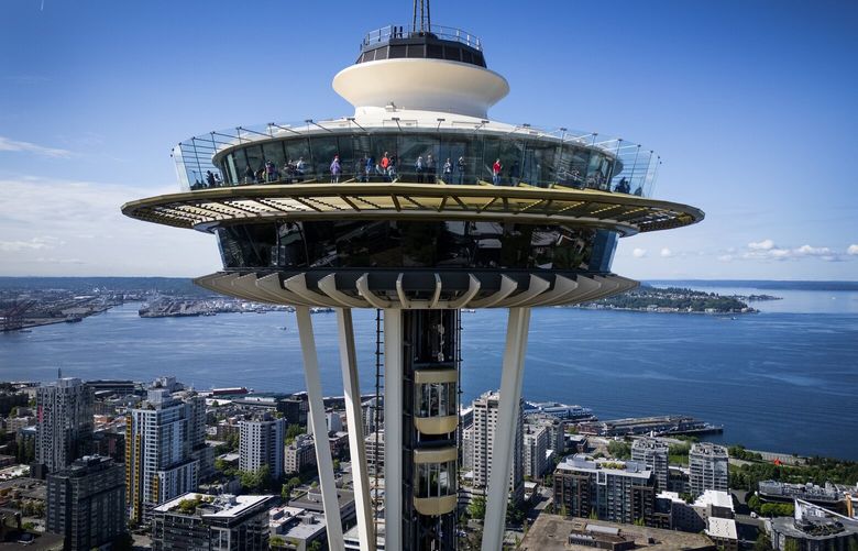 The Space Needle’s new all-glass, double-deck outdoor elevator is seen on the move, Thursday, May 22, 2025, in Seattle before opening to the public Friday. This first replacement elevator is on the north side of the needle and will open to passengers on two floors at once.