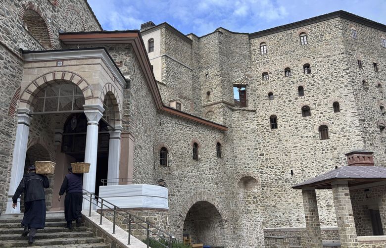 Monks carry baskets of supplies to the Simonopetra, or Simonos Petra Monastery, home of the all-male autonomous community of Agion Oros, or Holy Mountain, on the peninsula of Mount Athos in northern Greece,, Tuesday, April 15, 2025. (AP Photo/Thanassis Stavrakis) OTK412 OTK412