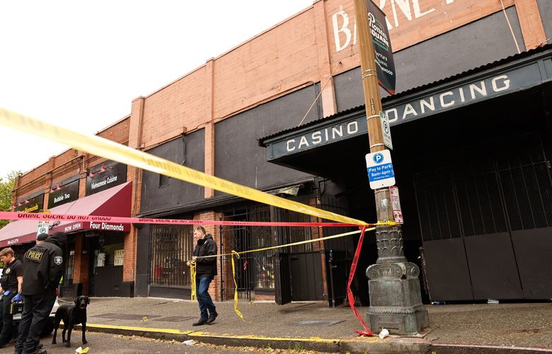 Seattle Police investigate the scene outside OHM Nightclub on S. Washington St. near where three people were killed and one other critically wounded in a shooting in the Pioneer Square neighborhood of Seattle on Saturday, May 17, 2025. S. Washington St was blocked off between 2nd Ave S. and Occidental Ave. S.